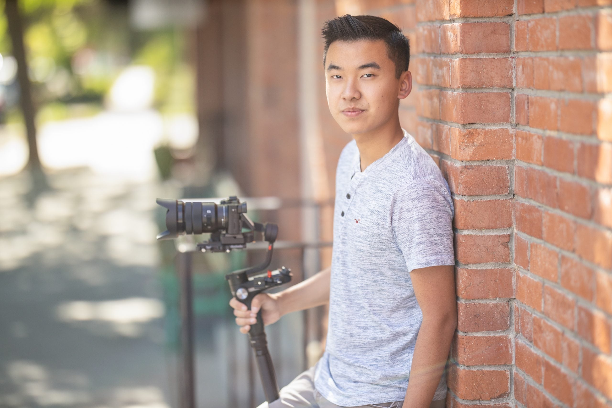 Yuan-zhen-senior-portrait-videographer-samuel-marvin-photography Young man with camera and video equipment