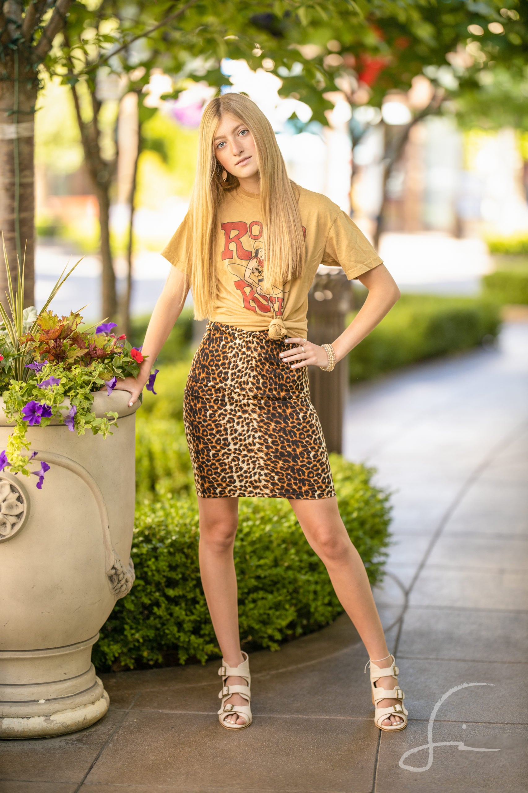 high school teen girl in a sassy outfit with a graphic tee and skirt.