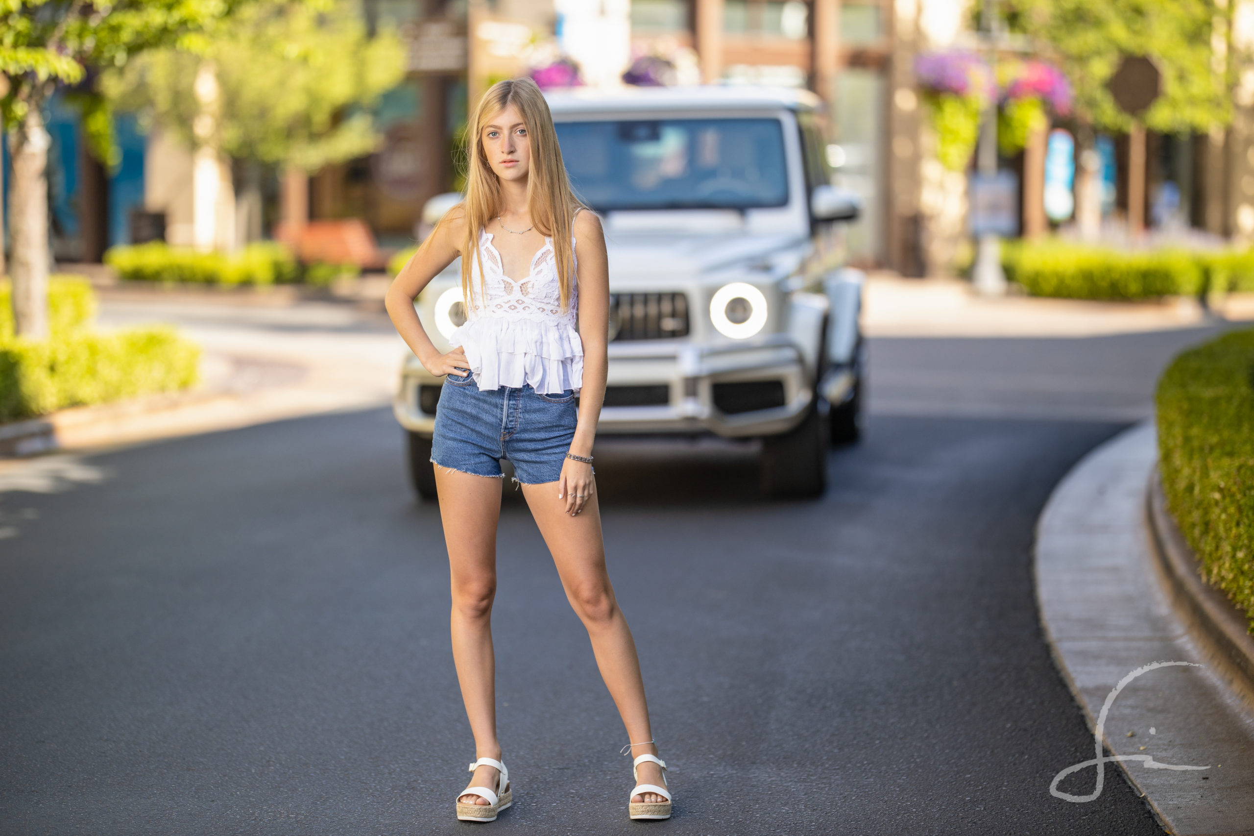 young girl in road in a tank top and shorts 