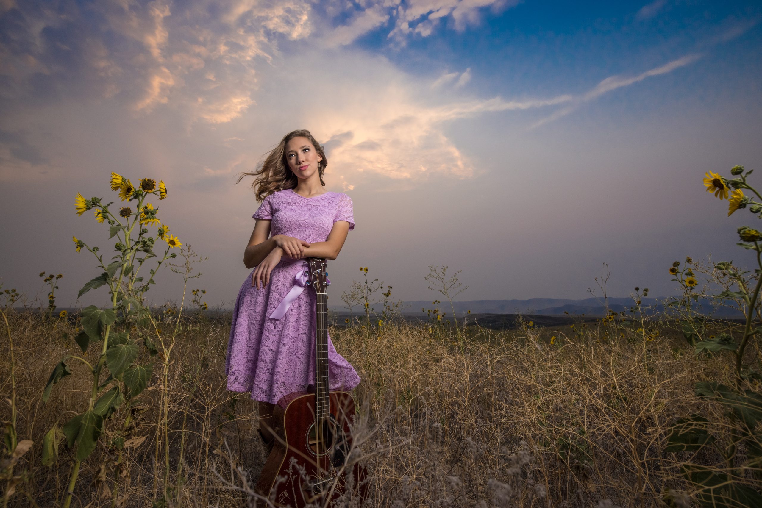 high school senior girl with her guitar at sunset in Eagle Idaho for senior pictures